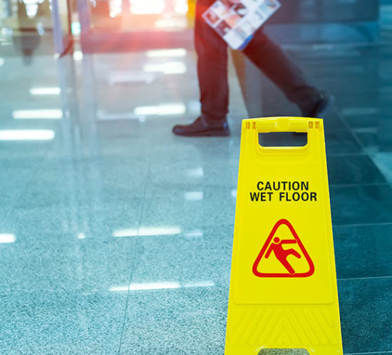 A wet floor sign covered by employers and public liability insurance with Insure 313.